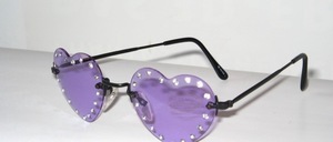 Rimless 4 - hole ladies sunglasses in matt black, with heart - shaped bright purple discs and large rhinestones surrounding them