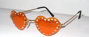 Rimless 4 - hole ladies sunglasses in gold, with heart - shaped bright orange discs and big rhinestones around it