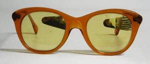 A funny night driving glasses with yellow mineral glass which is mirrored on the left side on each glass to darken the light of oncoming traffic