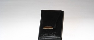 A small faux leather case in black, for folding glasses