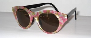 Modern, timeless pink pastel sunglasses with black inner frame and black temples