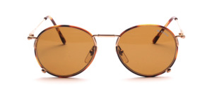 A rather round metal sunglasses covered with brown spotted windsorring rings