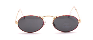 Oval ladies sunglasses in gold with pink patterned glass rim