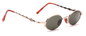 Oval gold sunglasses with green lenses and flared temples
