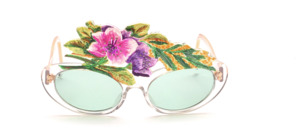 These glasses made by the artist show two colorful flower blossoms decorated with rhinestones, which are framed by green foliage