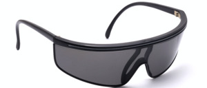 Light weight black plastic sunglasses from the 1980s with a fine white stripe on top and grey lens