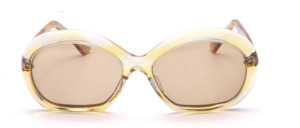 Of the hand of the french design icon Paulette Guinet is this vintage treasure from the late 1960s has a yellowish transparent frame, round shape with silver studs