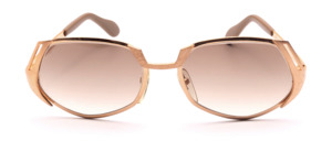 Vintage 1970s Neostyle Model 311 sunglasses in gold, featuring an oval-rectangular shape and a finish that combines glossy and matte elements