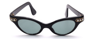 Vintage 1950s butterfly cat-eye sunglasses in black acetate with rhinestone and gold embellishments, three small pearls at the temple base, and gray lenses