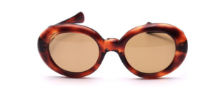 Oval sunglasses with a bold Havana brown acetate frame
